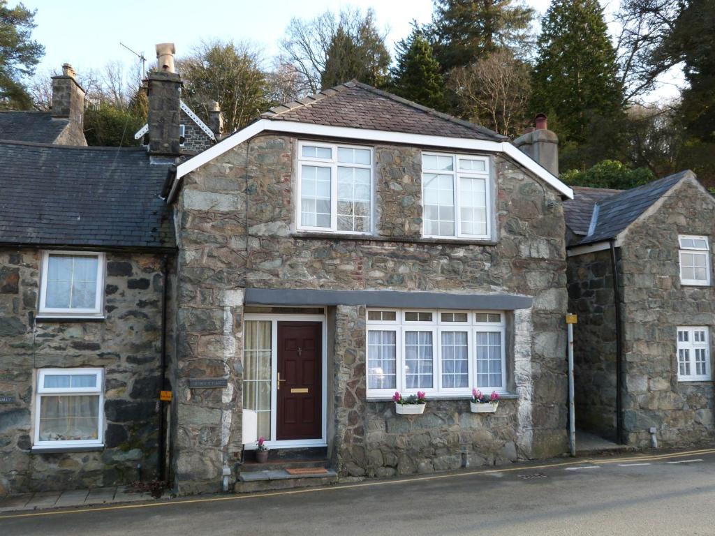 a stone house on the side of a street at Drws y Nant in Dolgellau