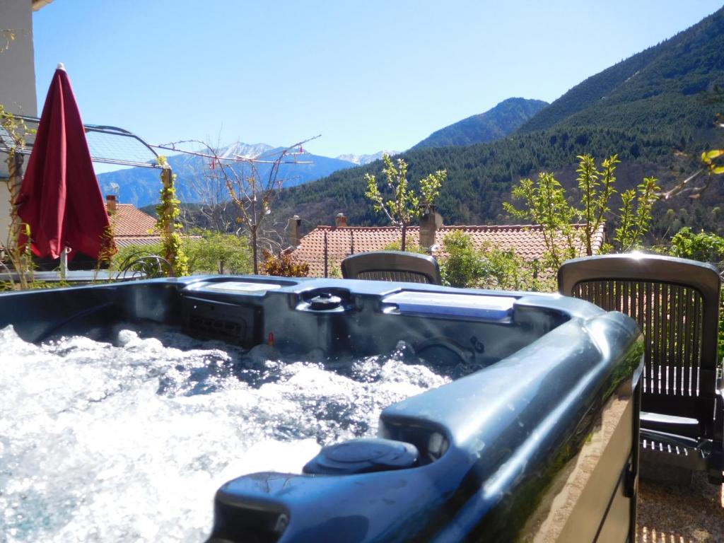 a water slide in a backyard with mountains in the background at le balcon du Canigo' in Escaro