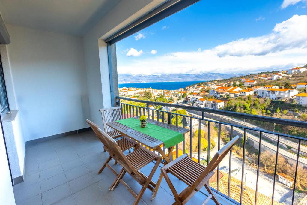 a balcony with a table and chairs and a view at Apartman Dokić 3 in Vrbnik