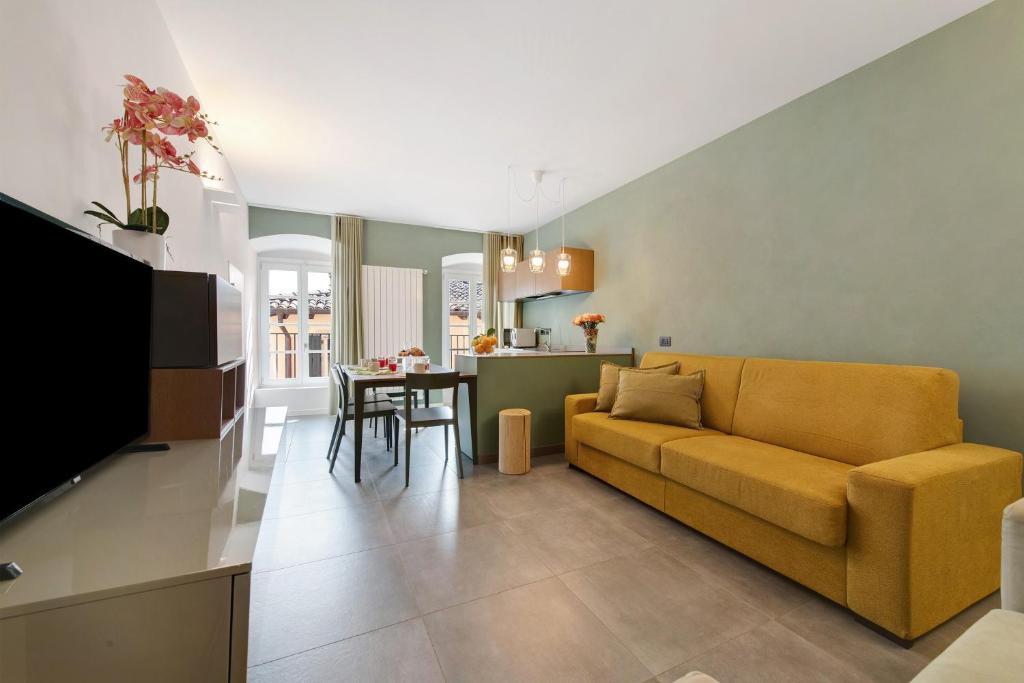 a living room with a couch and a table at Gemhouse Smeraldo garda lake in Gargnano