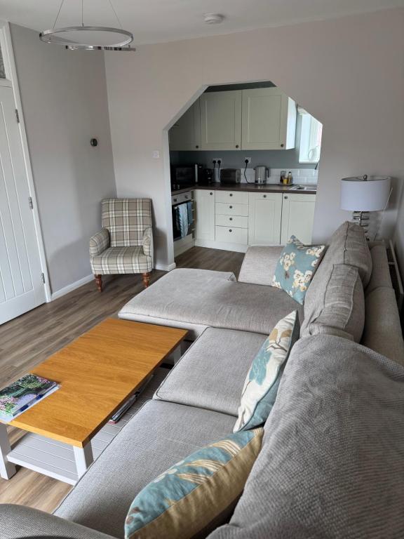 a living room with a couch and a table at Rooftops in Louth