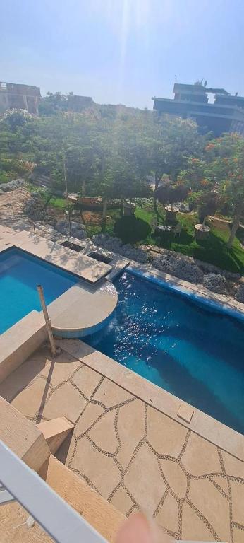 a view of a swimming pool with a chair next to it at الريف الاوربي in Cairo