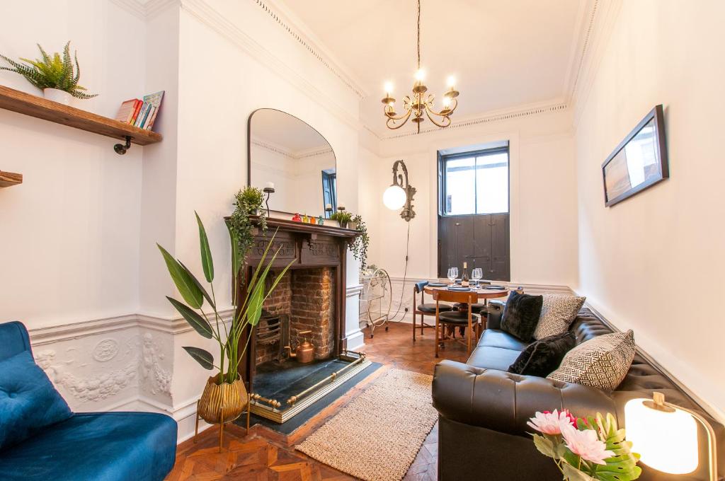 a living room with a couch and a fireplace at Cobb's Margate Old Town Hideaway in Margate