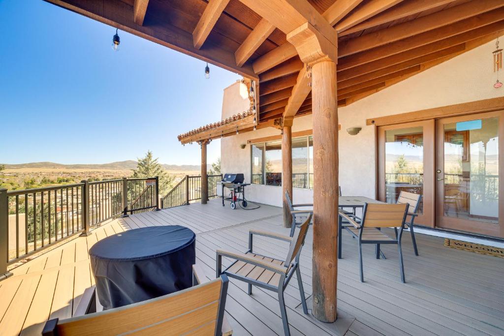 a porch with a table and chairs on a deck at Golfer's Haven! Mtn-View Dewey Gem w/ Pool Access in Dewey