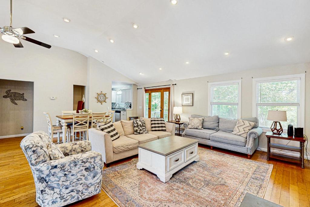 a living room with a couch and a table at Sandy Feet Retreat in Kill Devil Hills