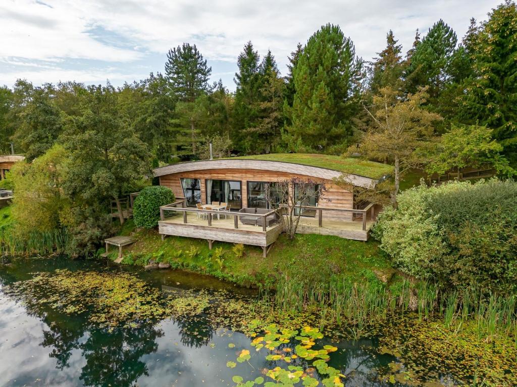 a house with a green roof and a pond at Abbey in Richmond