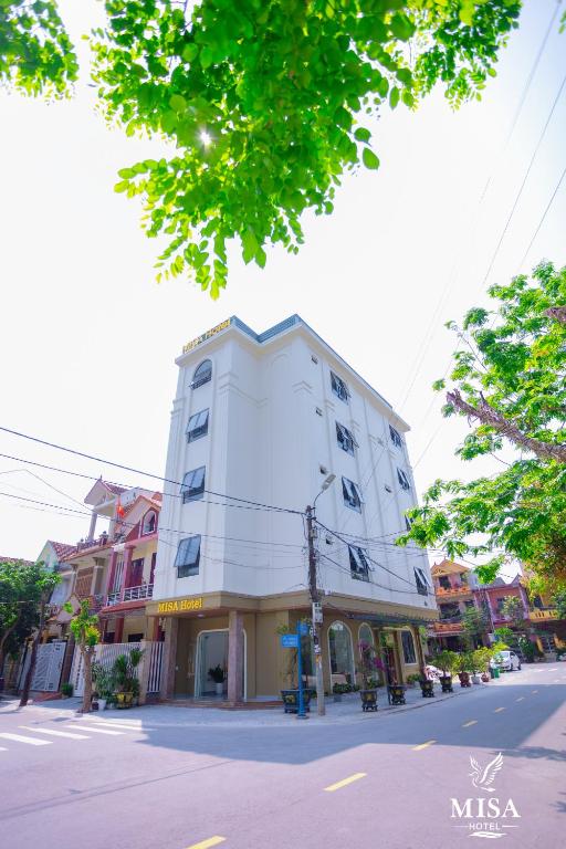 a white building on the side of a street at MISA Hotel in Dong Hoi