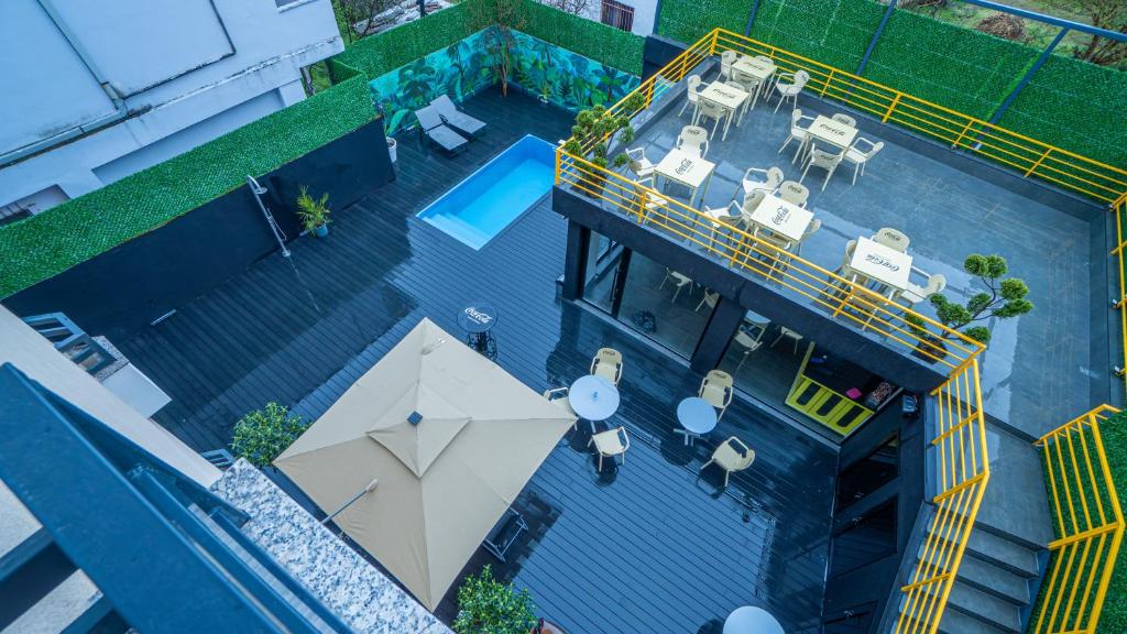 an overhead view of a swimming pool with an umbrella at 7even Boutique Hostel in Tirana