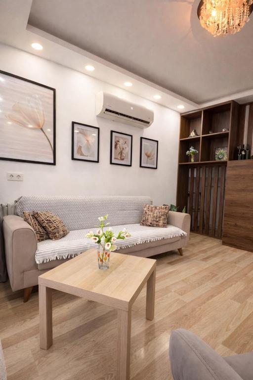 a living room with a couch and a table at dupleqs batumi daRia in Angisa