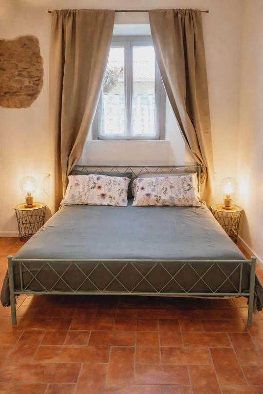 a bed in a room with a window at B&B La Corte del Segrino in Canzo