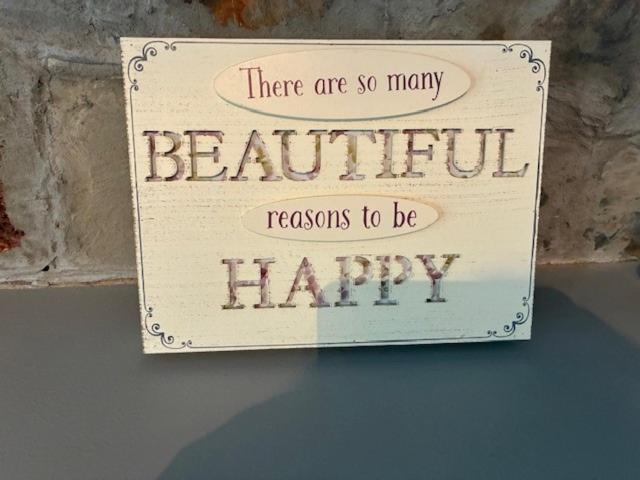 a sign that says there are so many beautiful reasons to be happy at Bramble Lodge in West Chevington