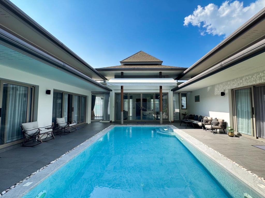 a swimming pool in front of a house at Luxury 3BR Pool Villa Private Pool Quiet Area in Ban Klang