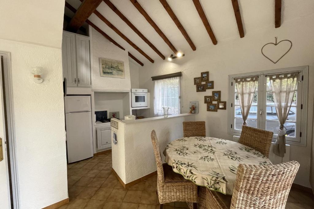 a kitchen and dining room with a table and chairs at Charming house just a few minutes from the beach in Sainte-Maxime