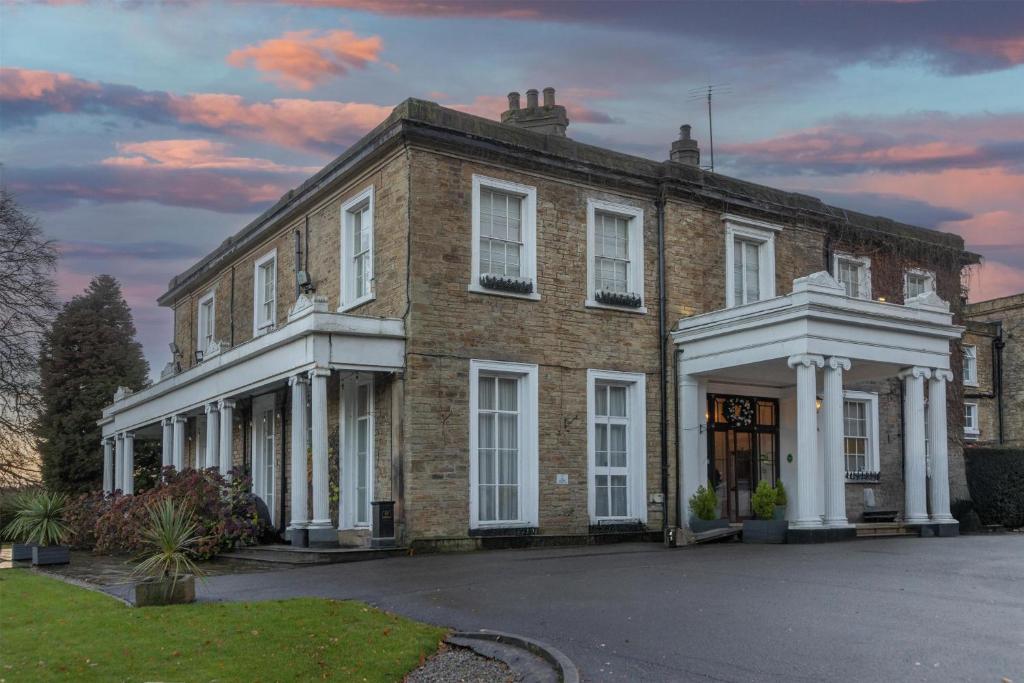 a large brick building with white columns at Ringwood Hall Hotel & Spa, Best Western Signature Collection in Chesterfield