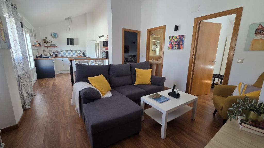 a living room with a couch and a table at Ático Vista La Sierra in Jarandilla de la Vera