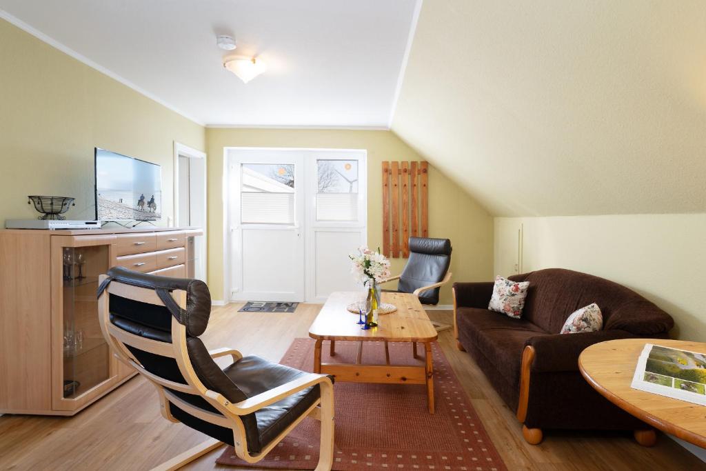 a living room with a couch and a table at Dorfstraße 28 Seerose in Klausdorf
