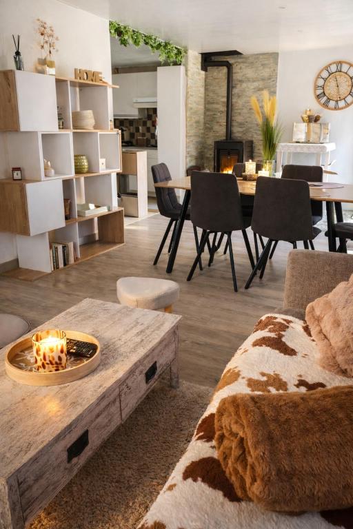 a living room with a couch and a table at Au Doubs lac, Cosy 4 pers Terrasse ,Ski et Nature in Malbuisson