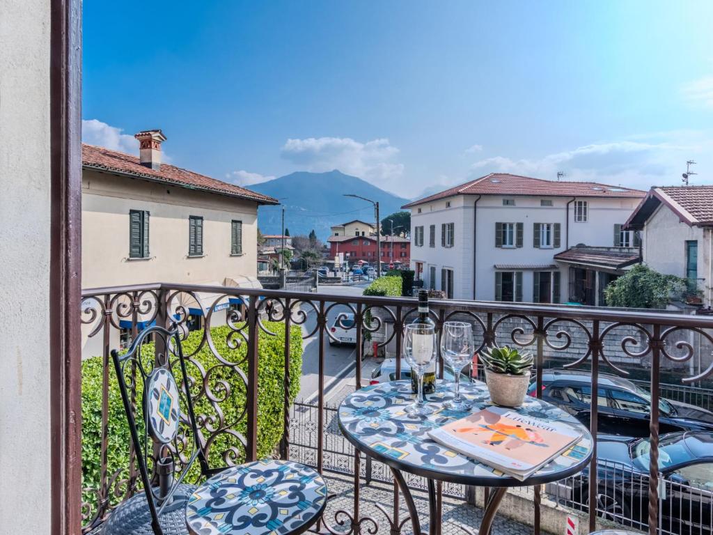 a table on a balcony with a view of a street at Apartment Casa Luvit by Interhome in Menaggio