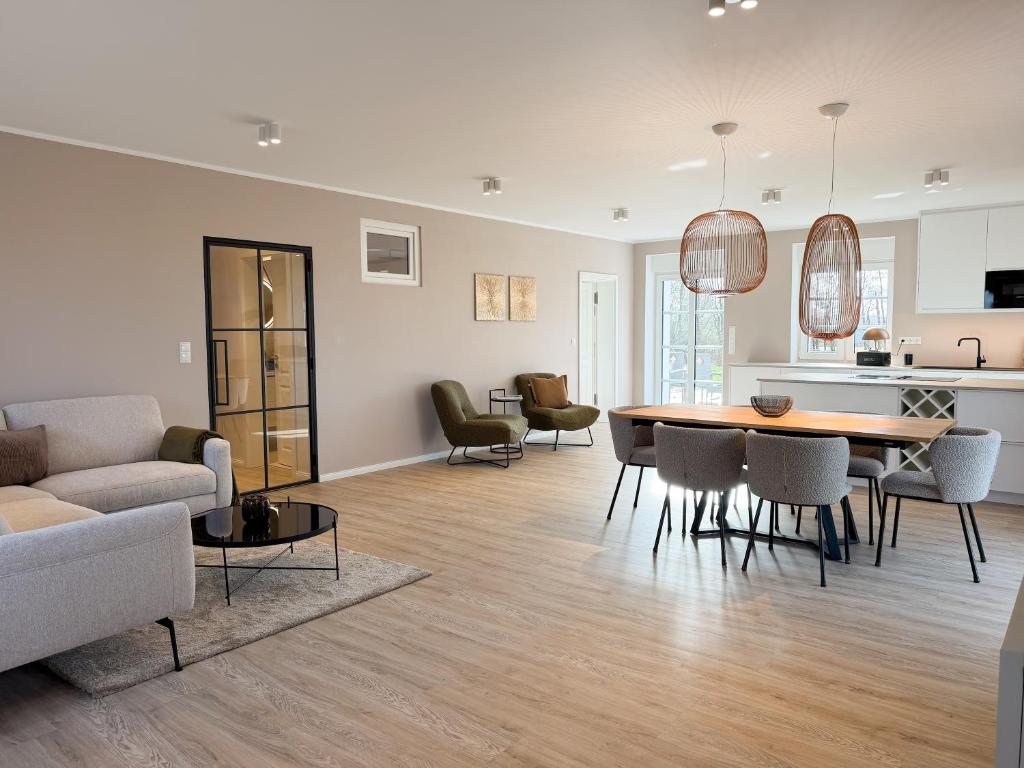 a living room and dining room with a table and chairs at Alte Wassermühle Nord in Börm