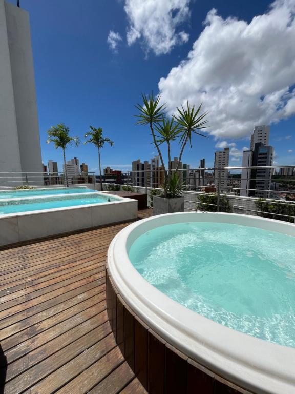 a hot tub on the roof of a building at Flat Manaira in João Pessoa