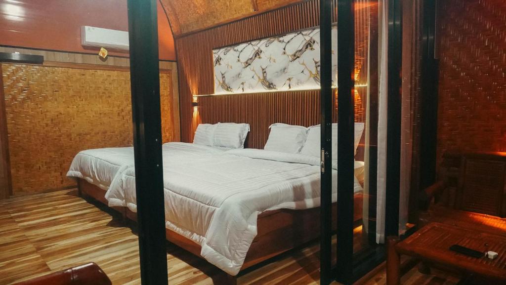a bedroom with a large bed in a room at Angghy Garden Tetebatu in Tetebatu