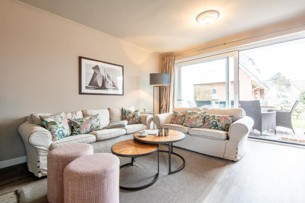 a living room with a couch and a table at Princessa Coast in Süderende