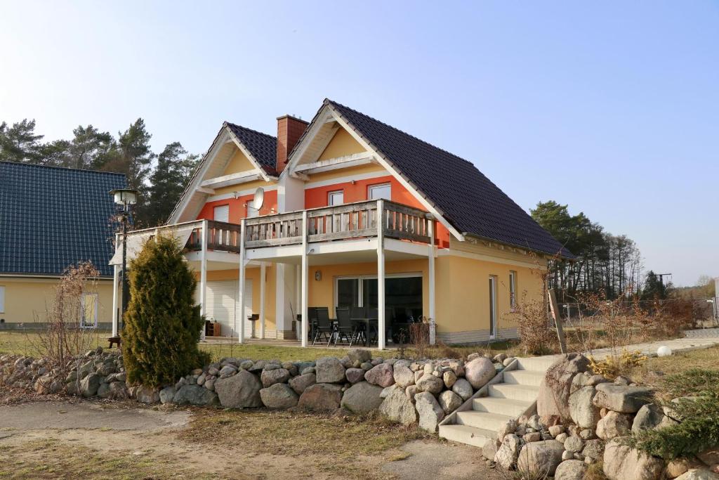 a house with a stone retaining wall at Seeluft in Warin