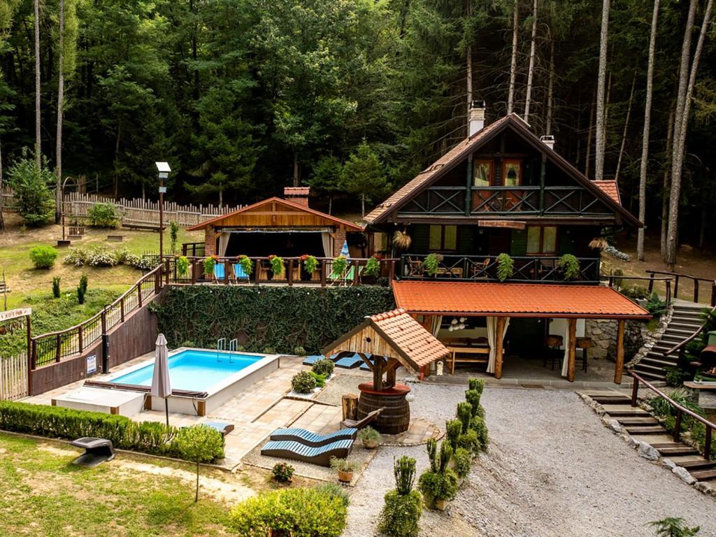 a house with a swimming pool in front of it at Chalet Pine Hill by Interhome in Klenovnik
