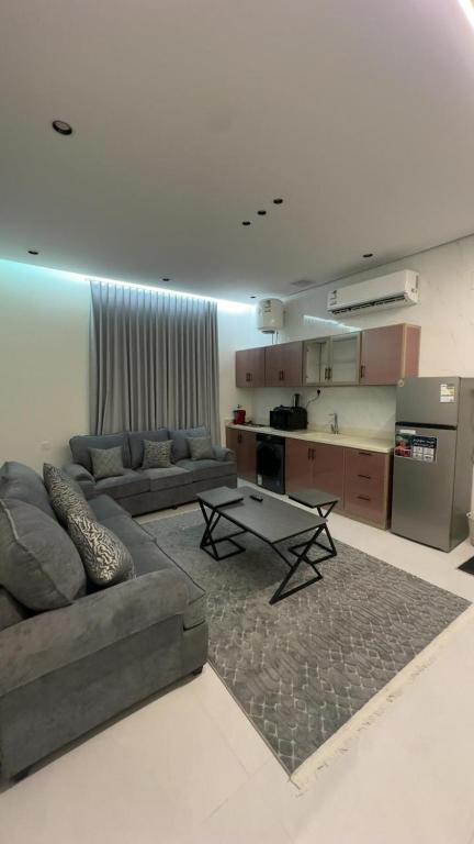 a living room with a couch and a table at TwentyFour Seven Residence in Tabuk