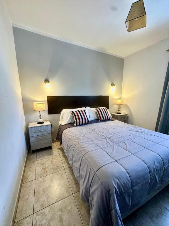 a bedroom with a large bed and two night stands at Hotel Estrella Andina in San Juan
