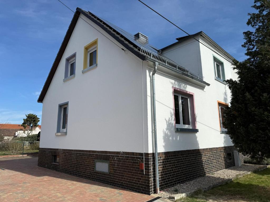 a white house with a black roof at Ferienhaus Halbritter Pouch 2 in Pouch