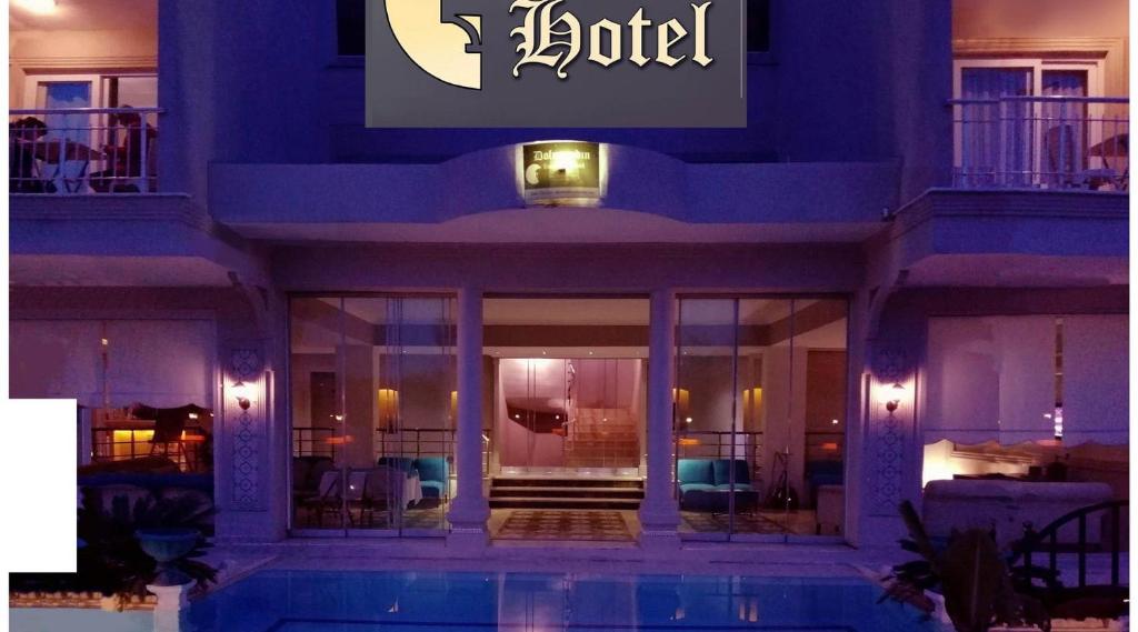 a hotel with a swimming pool in front of a building at dolunaydın hotel in Side