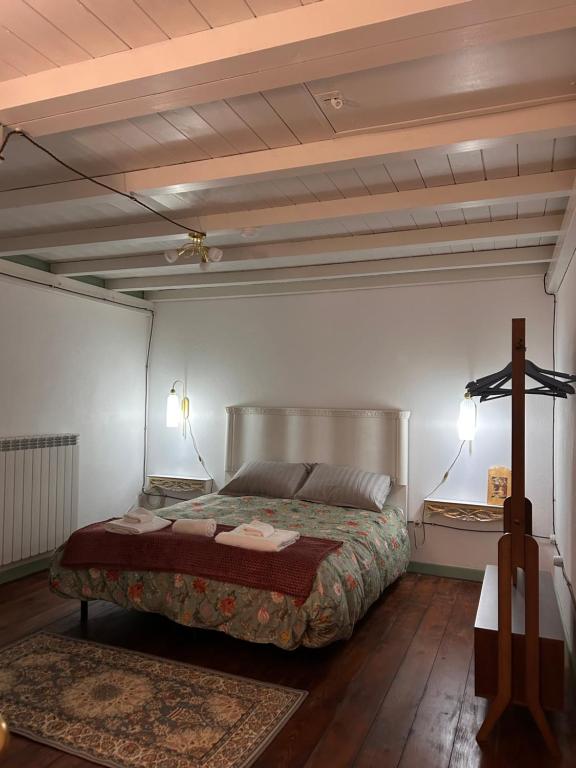 a bedroom with a bed and a wooden floor at Civico 15 in Antrosano
