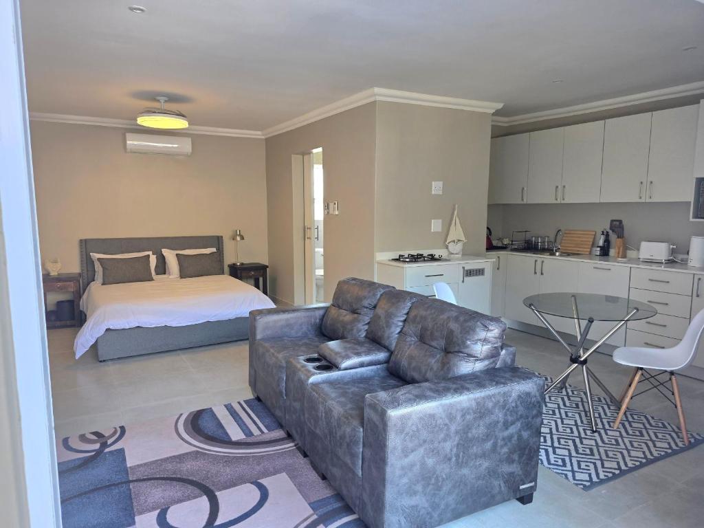 a living room with a couch and a bed at Miskin Place Unit 3 in Pennington