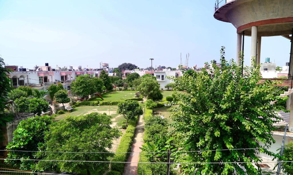 a view of a park with trees and buildings at Tuk Tuk Homestay in Agra