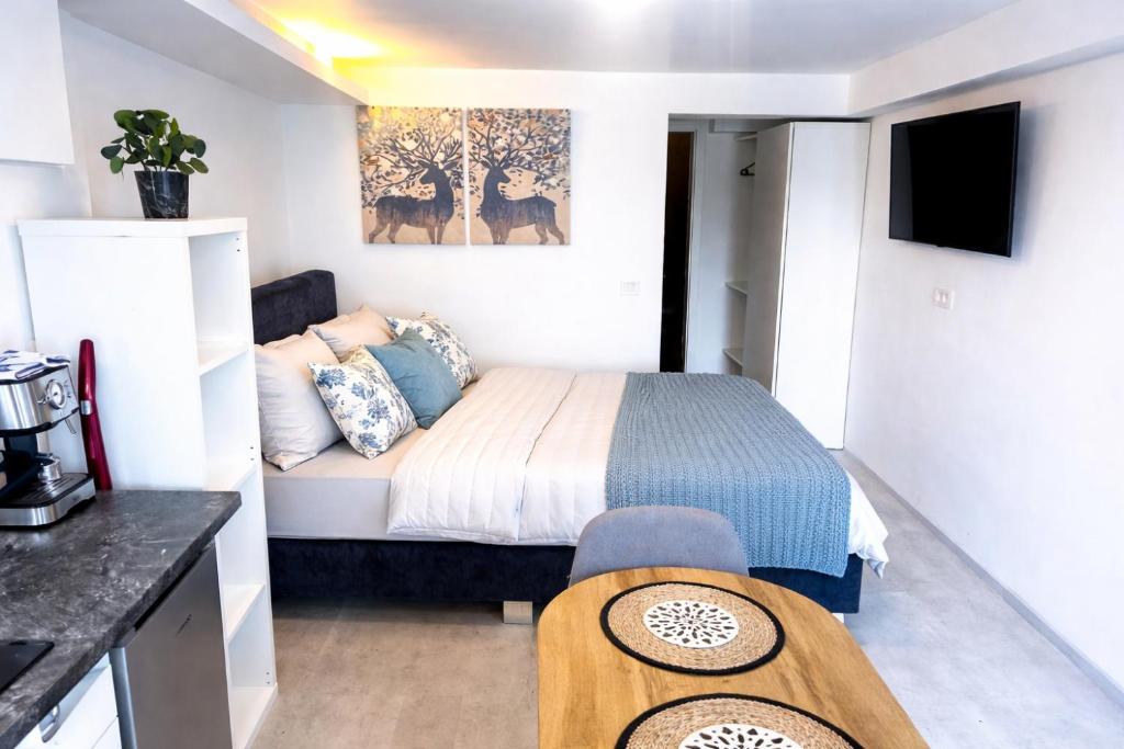a small bedroom with a bed and a table at Abby Apartment Koper in Koper