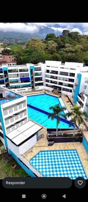 a large apartment building with a large swimming pool at Paraíso del sol in San Jerónimo