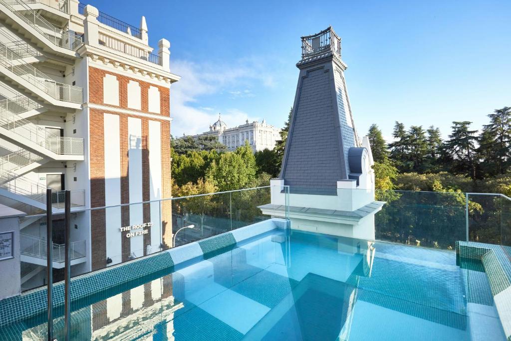a swimming pool with a lighthouse on top of a building at The Social Hub Madrid 4 star in Madrid