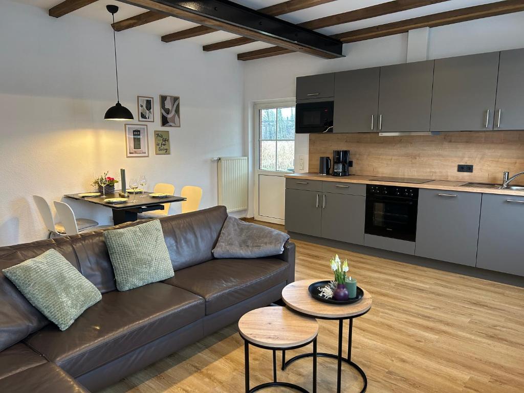 a living room with a couch and a kitchen at Landidyll Georg in Ostbevern