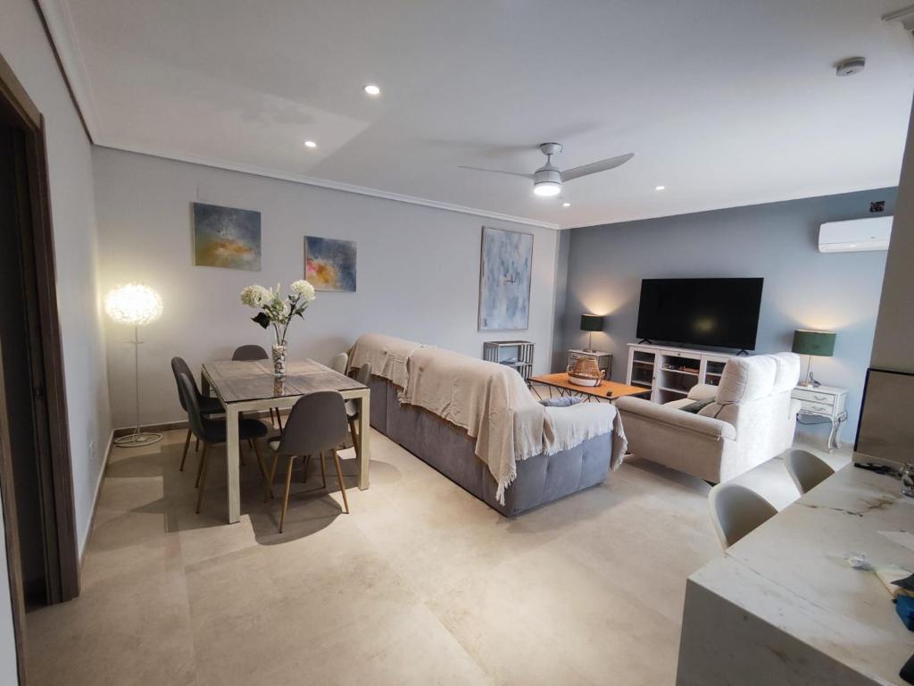 a living room with a bed and a dining room at Los Cipreses in Córdoba
