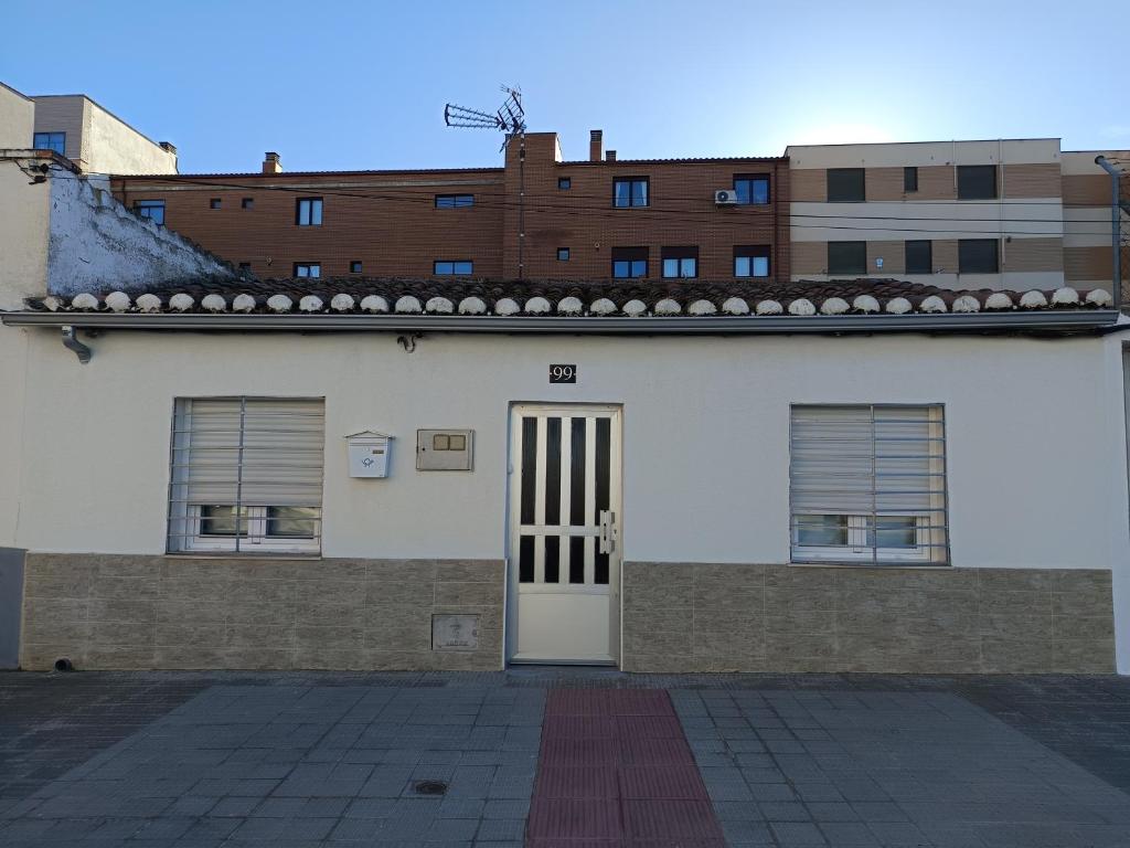 a white building with a door and some buildings at Casa Patio Zamora in Zamora