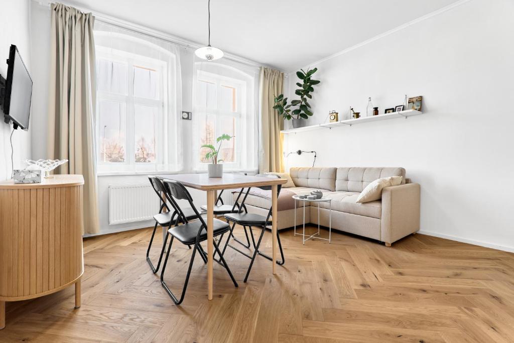 a living room with a table and chairs and a couch at O'Hara in Horní Blatná