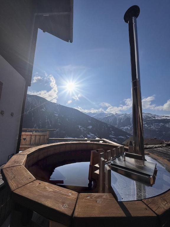 a hot tub with a view of the mountains at La Rose d Eva in Saint-Martin