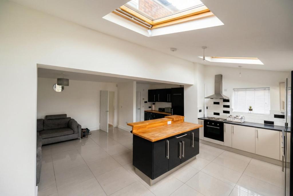a kitchen with a counter top in a room at Contemporary Private Home Near Nottingham with Free Parking and Garden in Sandiacre