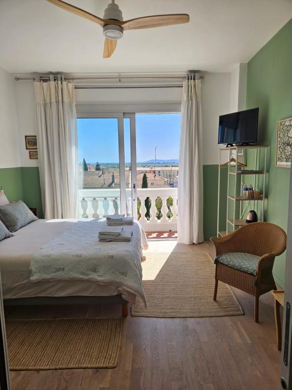 a bedroom with a bed and a window with a view at Villa Marguerite in Hyères