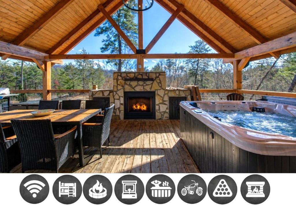 a patio with a hot tub and a fireplace at Makin' Memories cabin in Sevierville