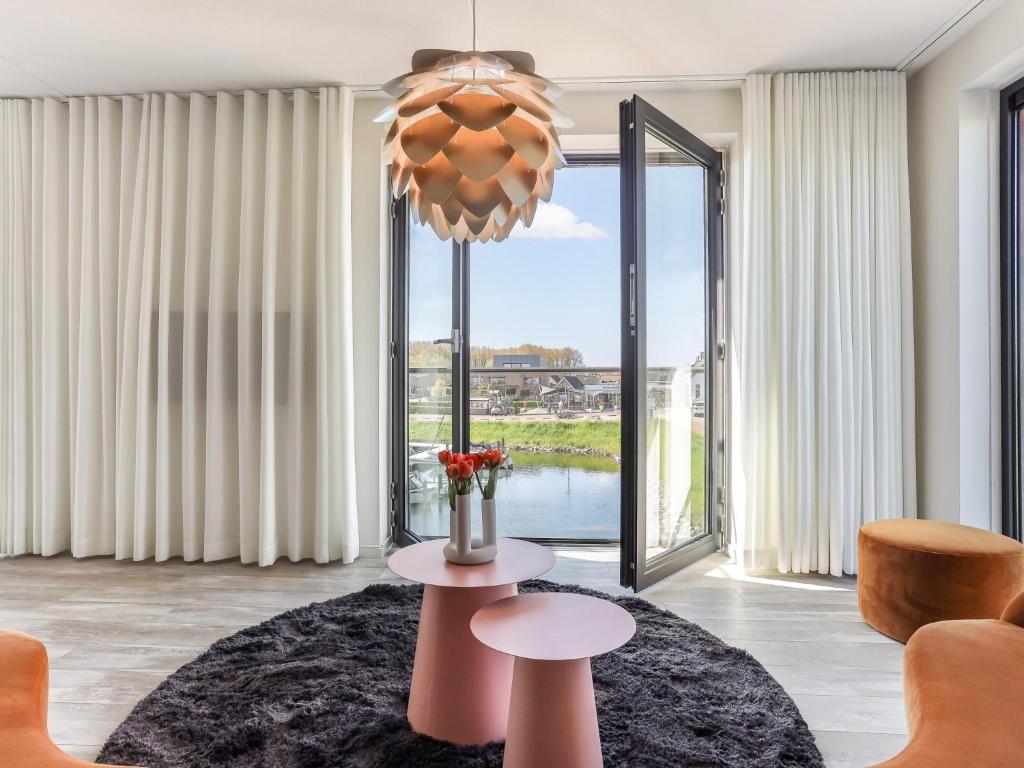 a living room with a table and a large window at Marina Vista in Kamperland