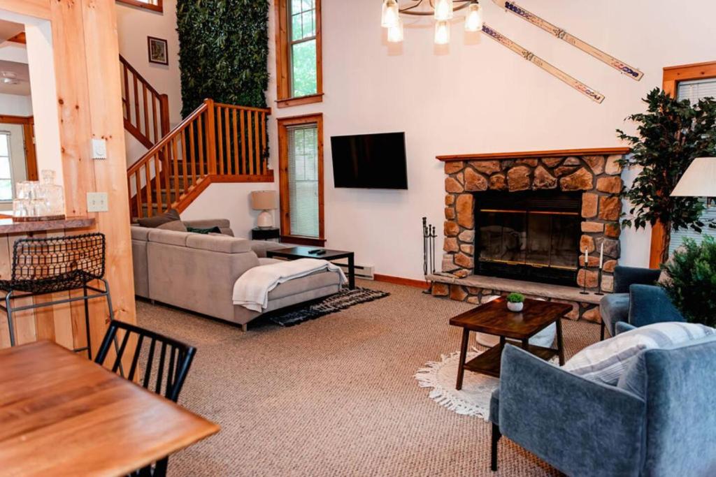 a living room with a couch and a fireplace at A Blind Camelback Mtn views 2m to slopes in Tannersville