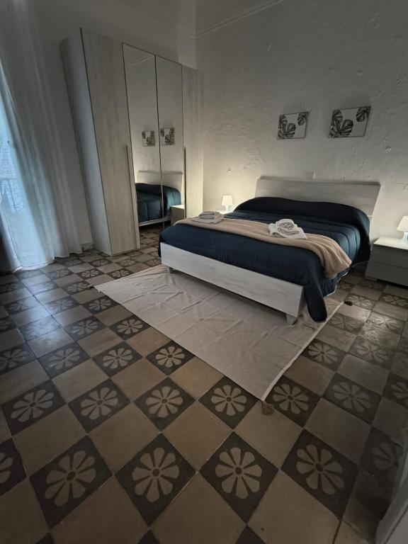 a bedroom with a bed and a tiled floor at IN CENTRO apartments in Torre Maggiore