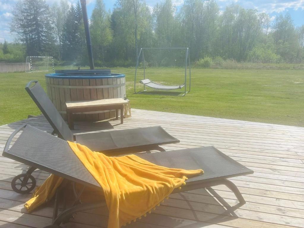 a blanket on a picnic table with a playground at Villa Nõva külalistemaja saunaga in Vaisi